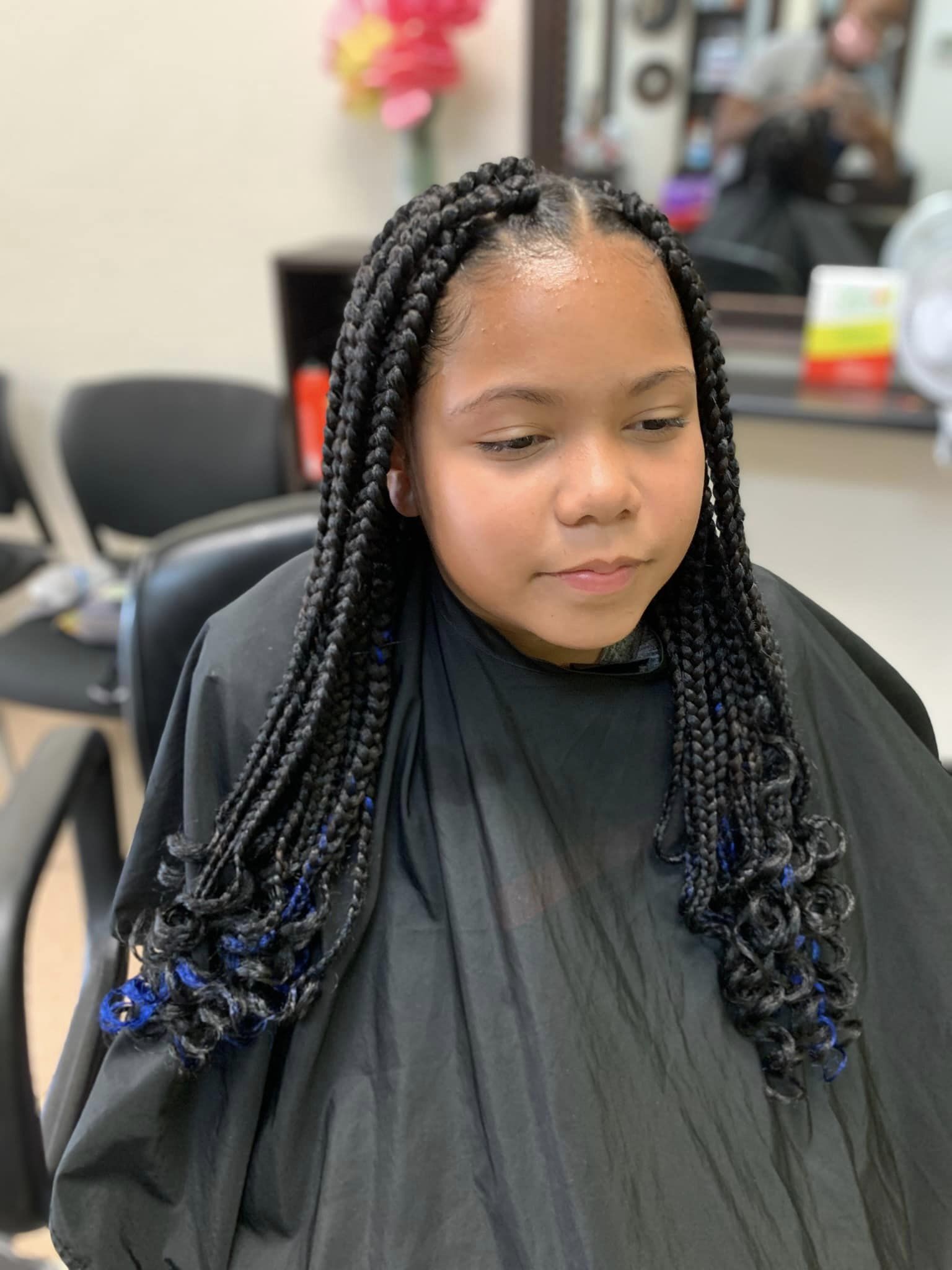 Classic box braids with blue accents on young client